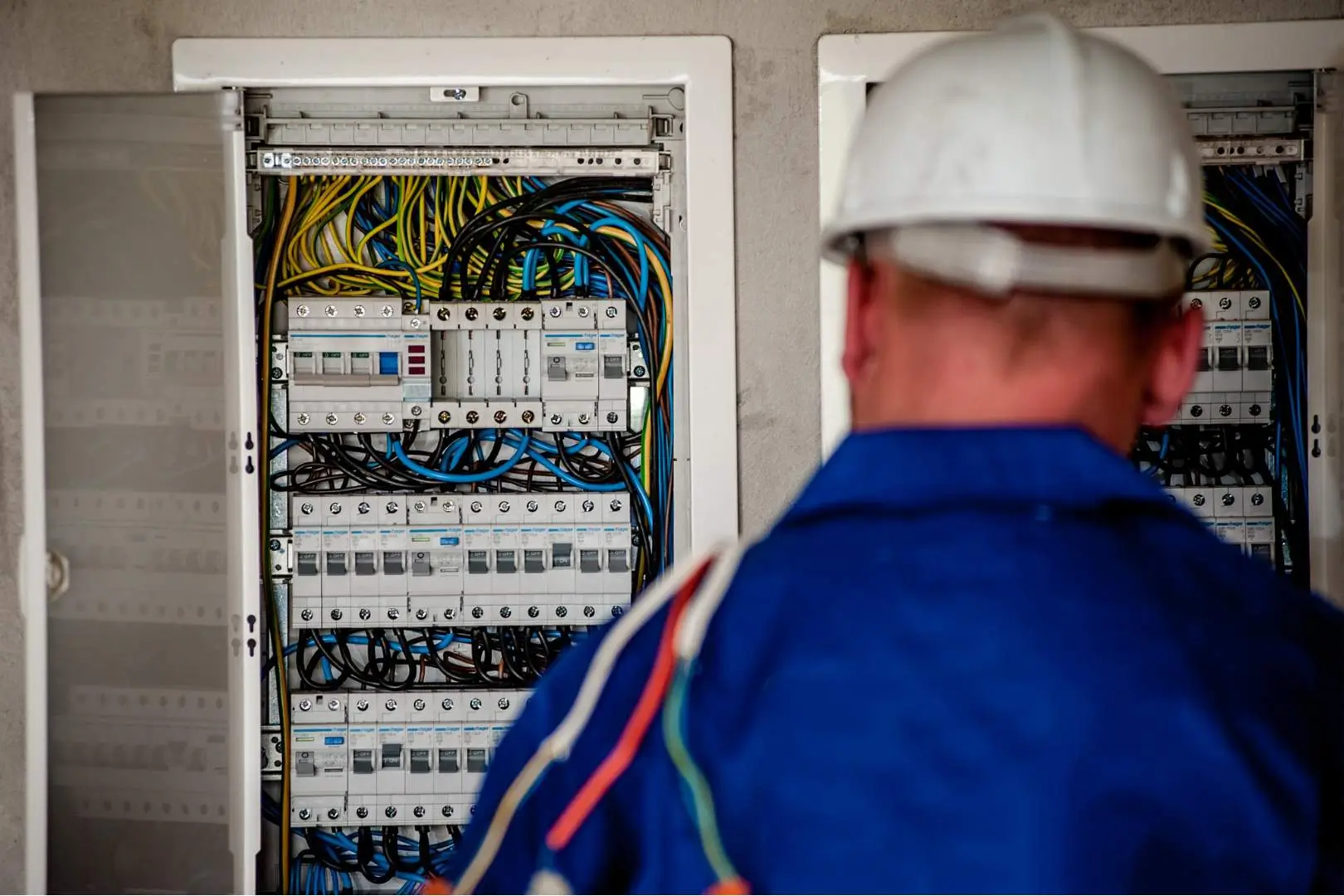 Electrician – Parramatta – Level 2 electrician inspecting complex switchboard cabling inside a commercial property.
